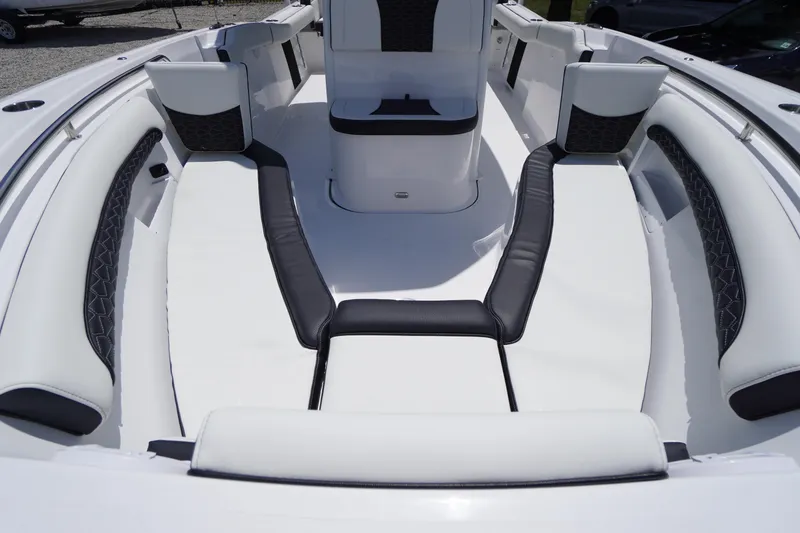 Slide: The Image of 2026 Tidewater 232 LXF boat interior with white and black cushioned seating. - 9