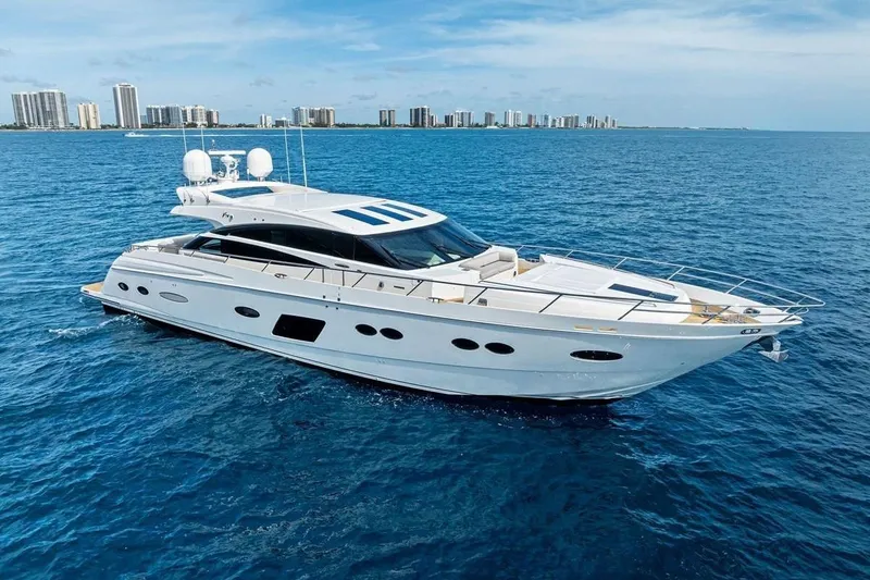 The Image of Luxurious 2013 Princess 78 yacht cruising on blue ocean near city skyline. - 0