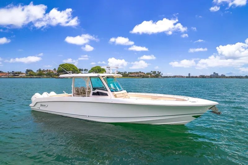 The Image of 2020 Boston Whaler 380 Outrage boat on clear blue water under a sunny sky. - 1