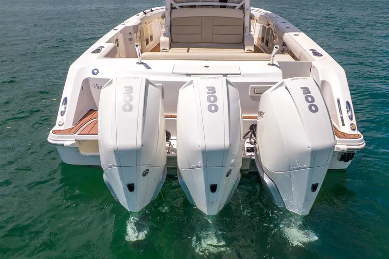 Slide: The Image of 2020 Boston Whaler 380 Outrage with triple Mercury 300 engines on open water. - 10