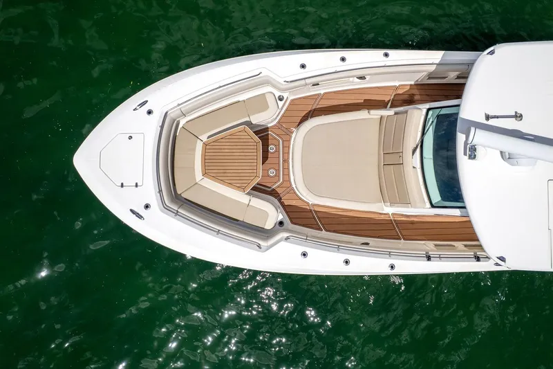 Slide: The Image of Aerial view of 2020 Boston Whaler 380 Outrage boat on green water. - 13
