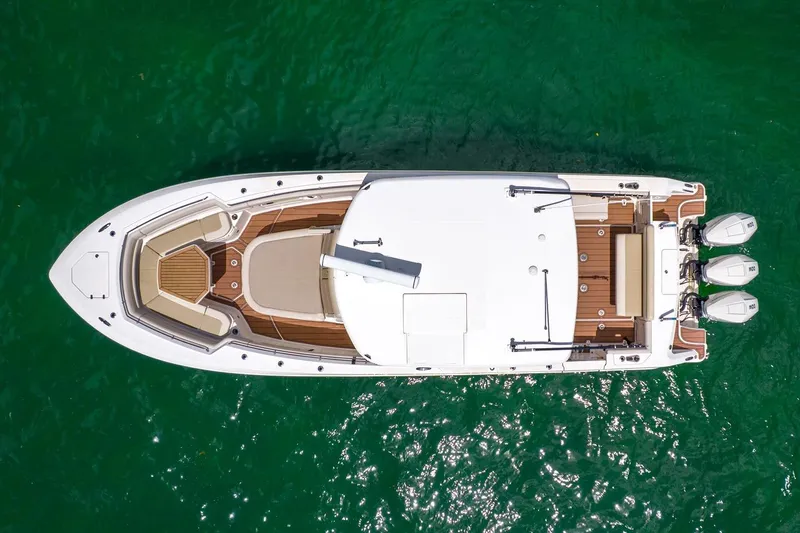Slide: The Image of Aerial view of 2020 Boston Whaler 380 Outrage boat on clear green water. - 14
