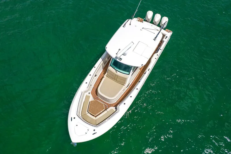 Slide: The Image of Aerial view of 2020 Boston Whaler 380 Outrage boat on clear green water. - 15