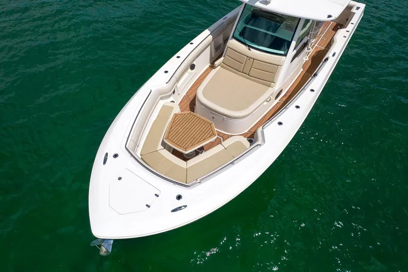 Slide: The Image of 2020 Boston Whaler 380 Outrage boat on clear green water, showcasing luxury seating. - 16