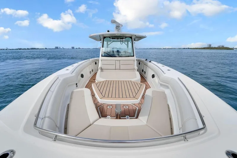 Slide: The Image of 2020 Boston Whaler 380 Outrage boat on open water, featuring spacious deck seating. - 17