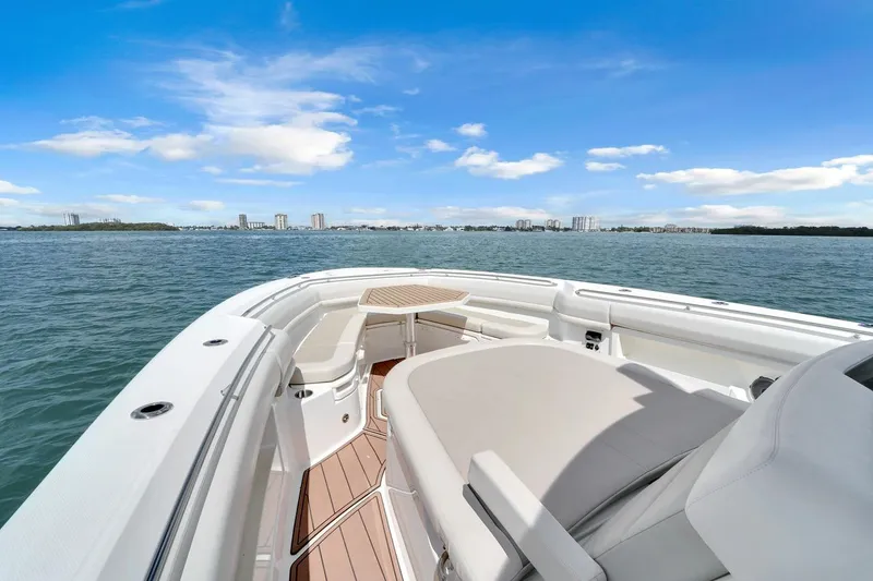 Slide: The Image of Boston Whaler 380 Outrage 2020 boat on calm water with city skyline view. - 21
