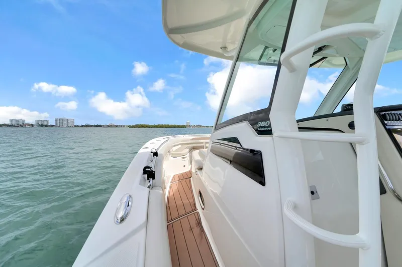Slide: The Image of 2020 Boston Whaler 380 Outrage boat on calm waters under a clear blue sky. - 22