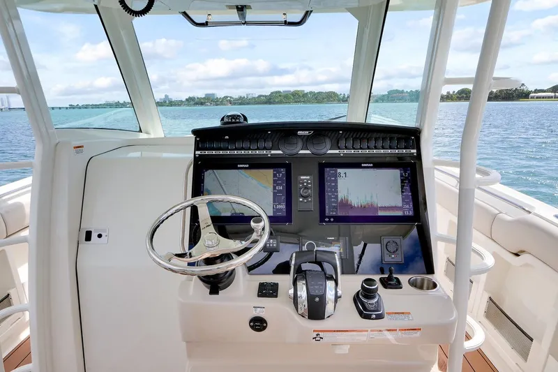 Slide: The Image of Helm of 2020 Boston Whaler 380 Outrage with advanced navigation displays and controls. - 23