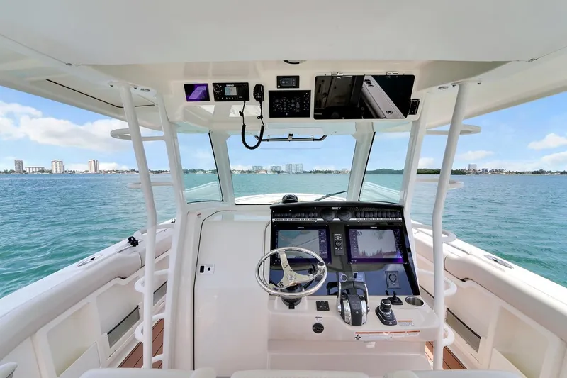 Slide: The Image of Cockpit view of 2020 Boston Whaler 380 Outrage boat on open water. - 24