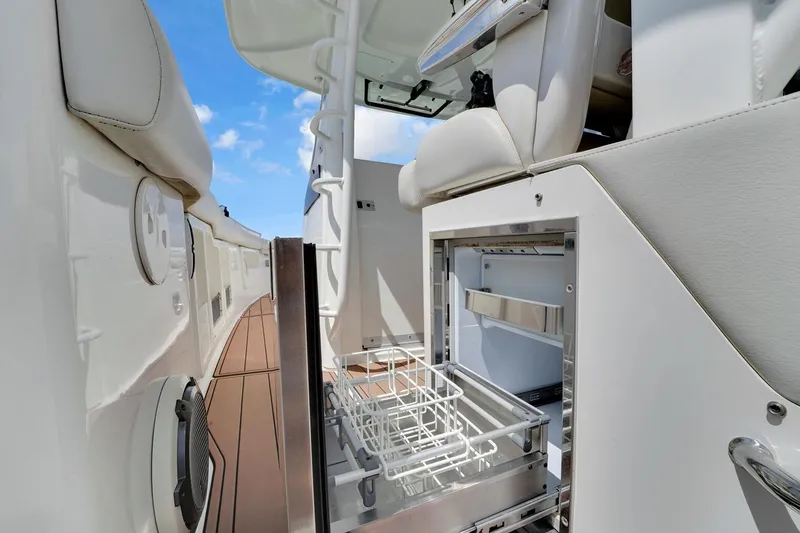 Slide: The Image of 2020 Boston Whaler 380 Outrage interior with open storage compartment and seating. - 27