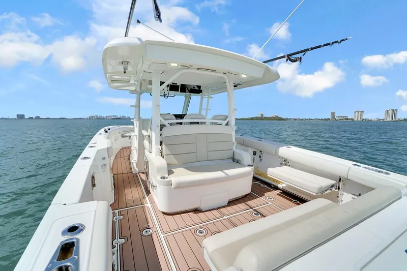 Slide: The Image of 2020 Boston Whaler 380 Outrage boat on water, featuring spacious deck and seating. - 29