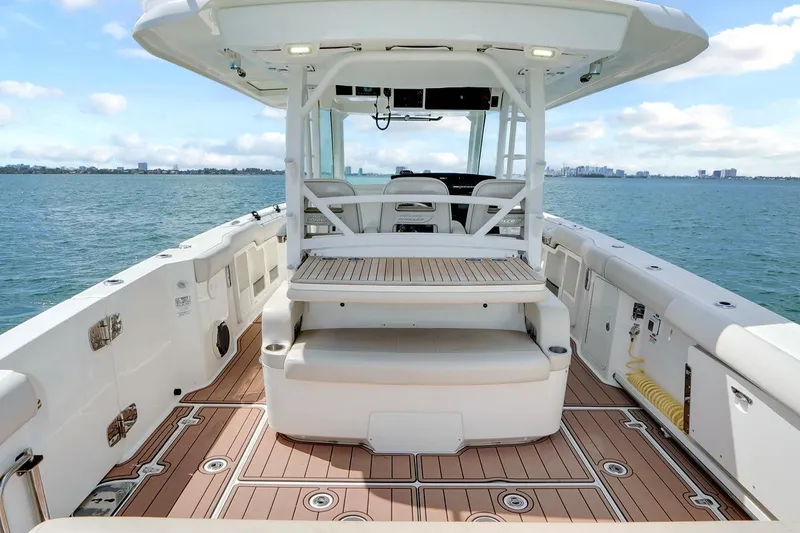 Slide: The Image of 2020 Boston Whaler 380 Outrage boat interior with spacious deck and seating on open water. - 31