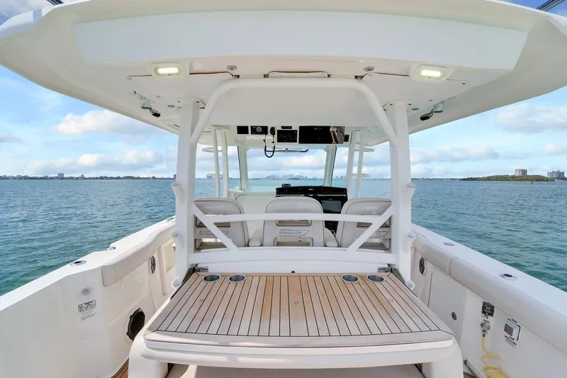 Slide: The Image of 2020 Boston Whaler 380 Outrage boat interior with seating and ocean view. - 32