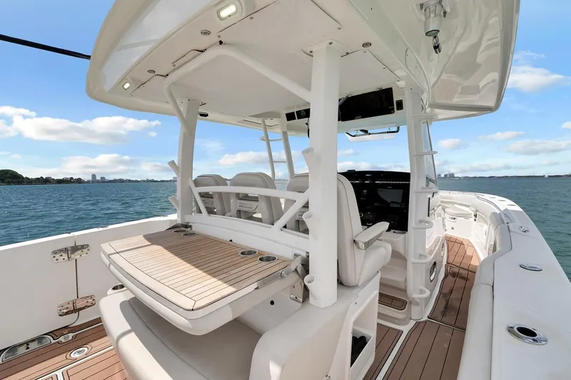 Slide: The Image of 2020 Boston Whaler 380 Outrage boat interior with seating and ocean view. - 33