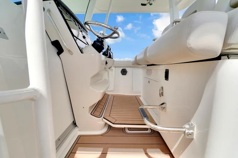 Slide: The Image of Interior view of 2020 Boston Whaler 380 Outrage boat, featuring sleek design and modern controls. - 35