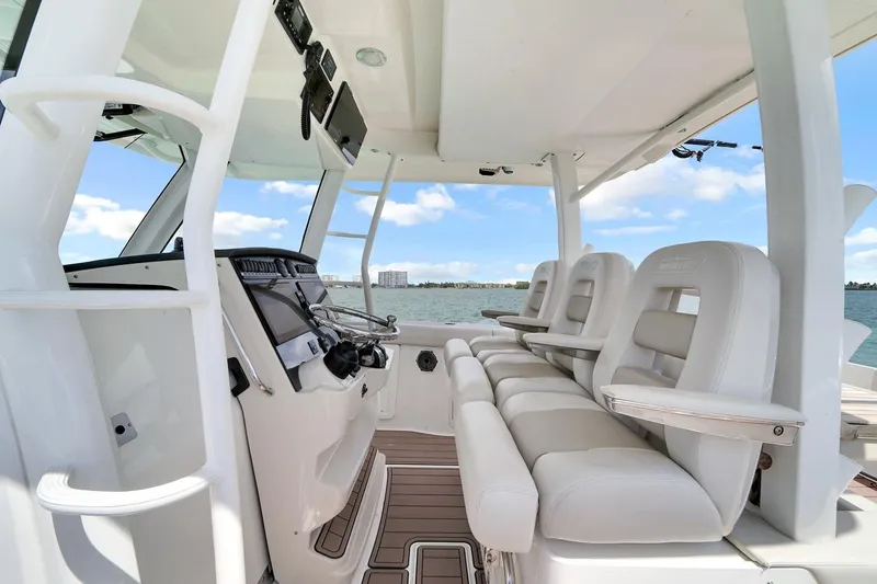 Slide: The Image of 2020 Boston Whaler 380 Outrage helm with luxurious seating and advanced controls. - 38