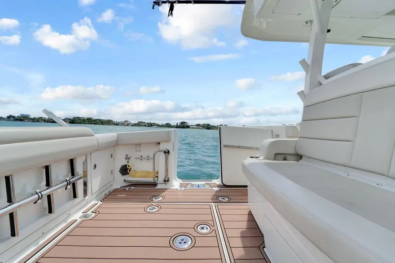 Slide: The Image of 2020 Boston Whaler 380 Outrage boat deck with seating, overlooking serene water and sky. - 42