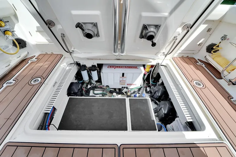 Slide: The Image of Engine compartment of 2020 Boston Whaler 380 Outrage, featuring Westerbeke generator and clean layout. - 43