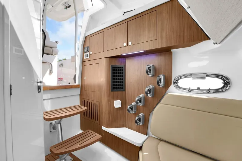 Slide: The Image of Interior of 2020 Boston Whaler 380 Outrage, featuring wooden cabinetry and seating. - 45