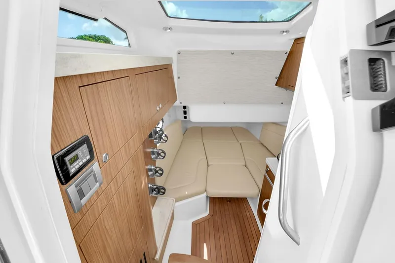 Slide: The Image of Interior cabin of 2020 Boston Whaler 380 Outrage, featuring wood cabinetry and beige seating. - 46