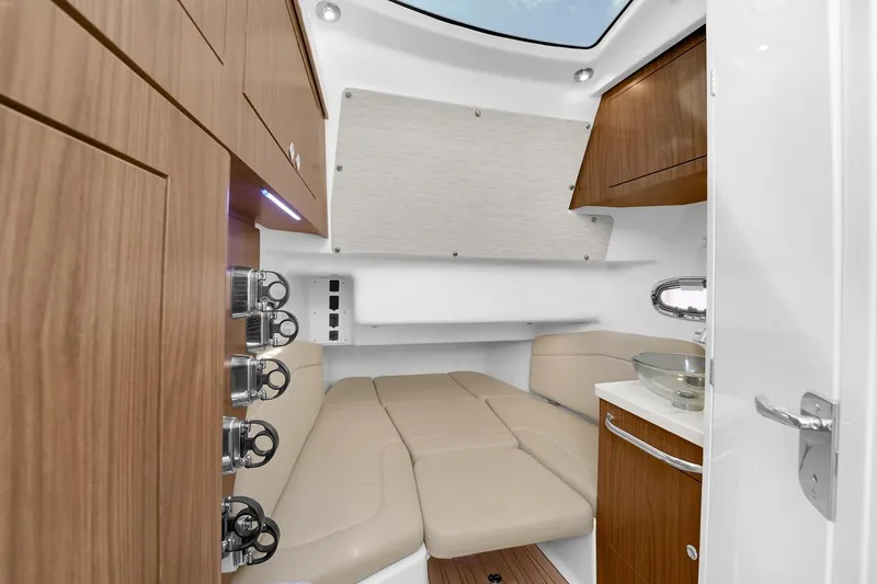 Slide: The Image of Interior cabin of 2020 Boston Whaler 380 Outrage with modern wood finish and seating. - 47