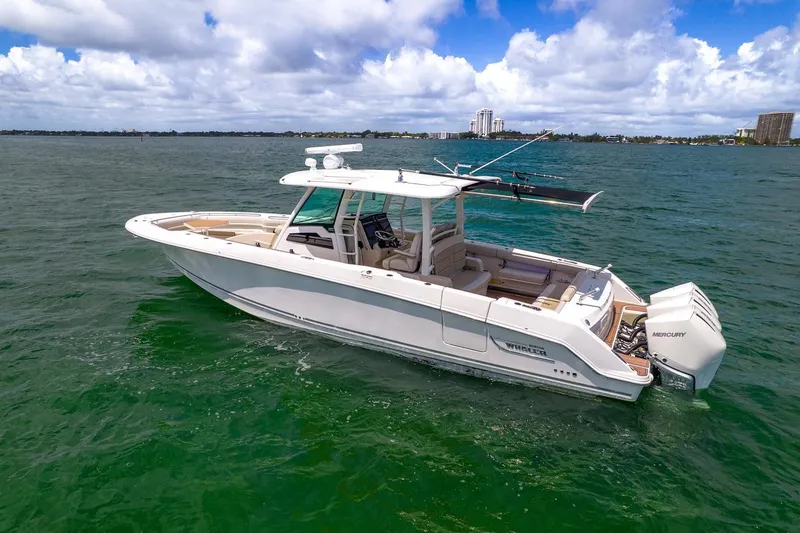 Slide: The Image of 2020 Boston Whaler 380 Outrage boat on open water under a blue sky. - 7