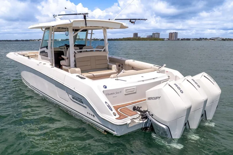 Slide: The Image of 2020 Boston Whaler 380 Outrage boat with triple Mercury engines on water. - 9