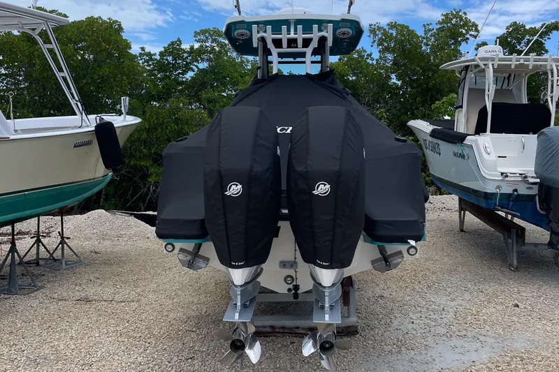 Slide: The Image of 2021 Blackfin 272 CC boat with covered engines, parked on gravel. - 11