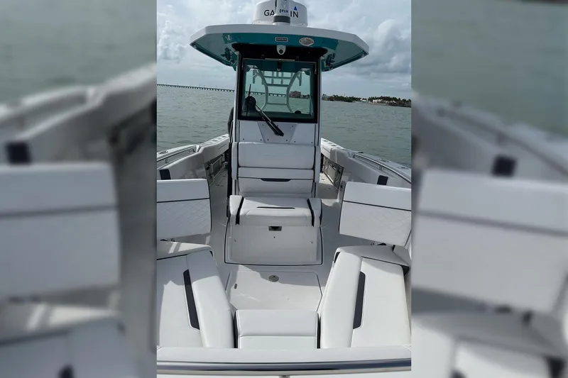 Slide: The Image of 2021 Blackfin 272 CC boat interior with seating, on calm water. - 14