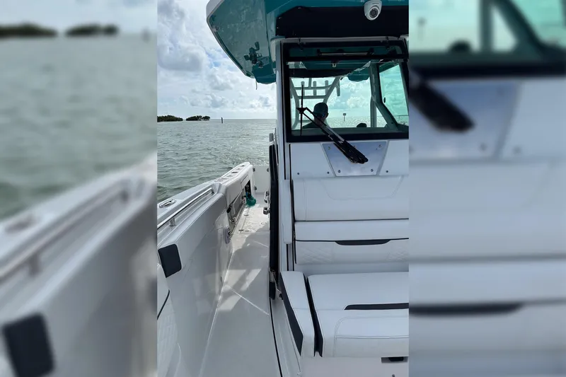Slide: The Image of 2021 Blackfin 272 CC boat on water, showcasing sleek design and spacious deck. - 16