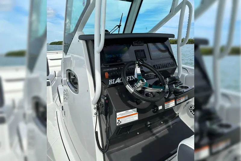Slide: The Image of 2021 Blackfin 272 CC boat helm with modern controls and navigation screens. - 17