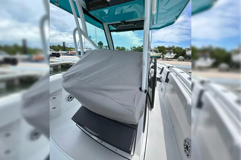 Slide: The Image of 2021 Blackfin 272 CC boat interior with covered console at marina. - 18