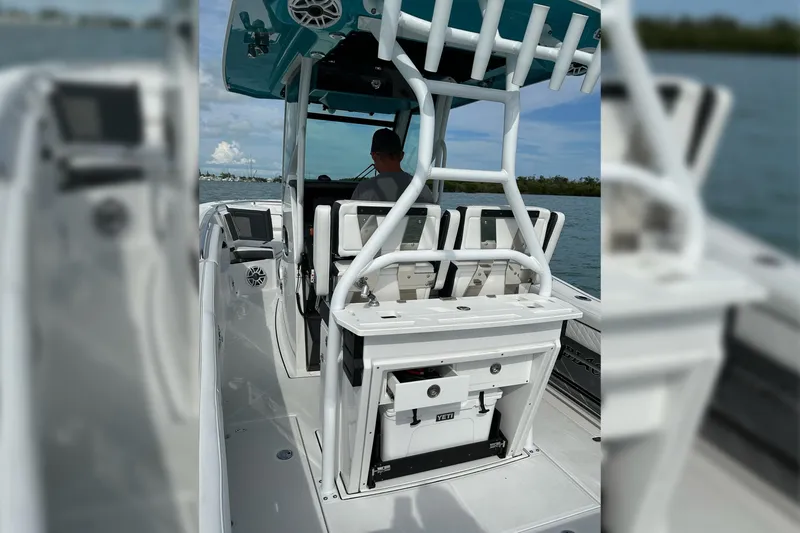 Slide: The Image of 2021 Blackfin 272 CC boat interior with seating and storage, cruising on water. - 21
