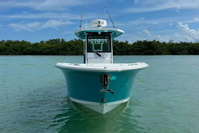 Slide: The Image of 2021 Blackfin 272 CC boat on calm water, clear sky background. - 6