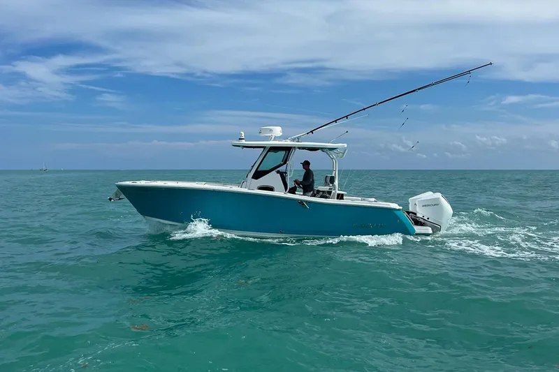 Slide: The Image of 2021 Blackfin 272 CC boat cruising on open sea under clear blue sky. - 9