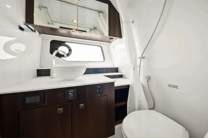Slide: The Image of Luxurious bathroom in 2024 Cruisers Yachts 42 GLS OB, featuring modern fixtures and elegant design. - 27