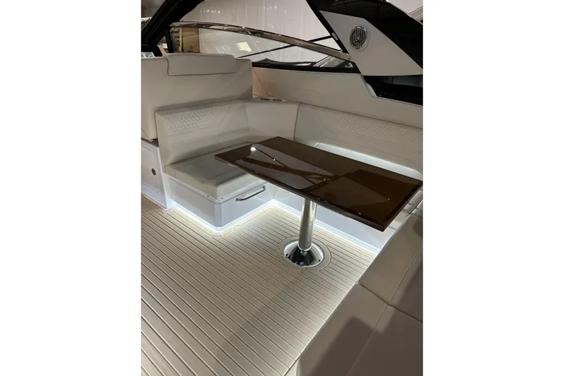 Slide: The Image of 2024 Cruisers Yachts 42 GLS OB interior with sleek seating and modern table design. - 17