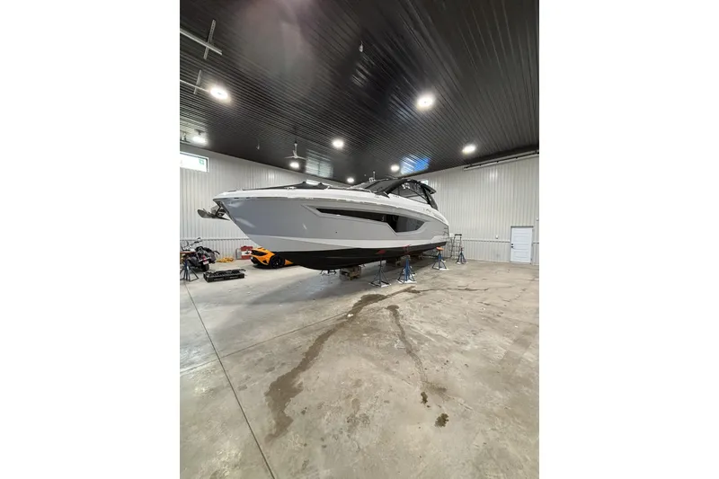 Slide: The Image of 2024 Cruisers Yachts 42 GLS OB in a spacious indoor storage facility. - 7