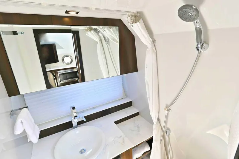 Slide: The Image of Luxurious bathroom in 2024 Cruisers Yachts 42 GLS OB with modern fixtures and elegant design. - 28