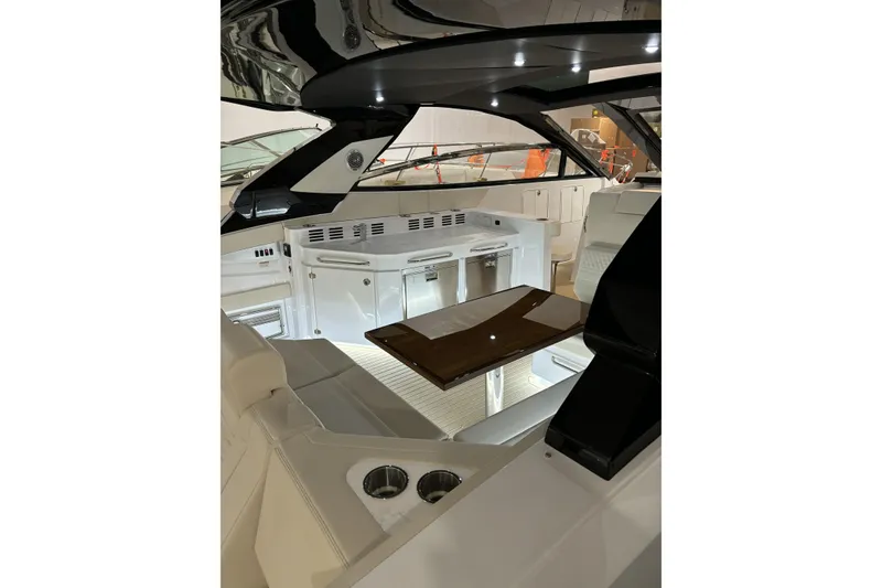 Slide: The Image of 2024 Cruisers Yachts 42 GLS OB interior with sleek seating and modern amenities. - 16