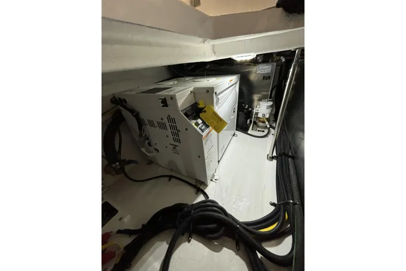 Slide: The Image of 2024 Cruisers Yachts 42 GLS OB engine compartment with electrical equipment and wiring. - 30