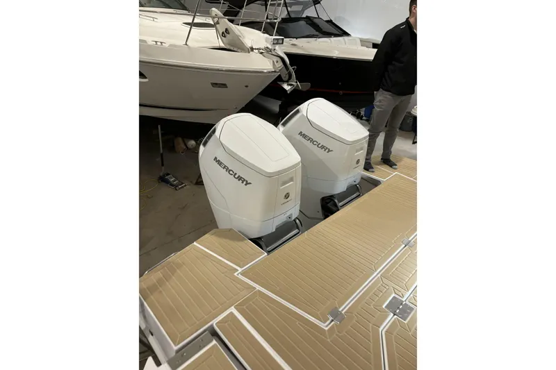 Slide: The Image of 2024 Cruisers Yachts 42 GLS OB with dual Mercury outboard engines in a showroom. - 11
