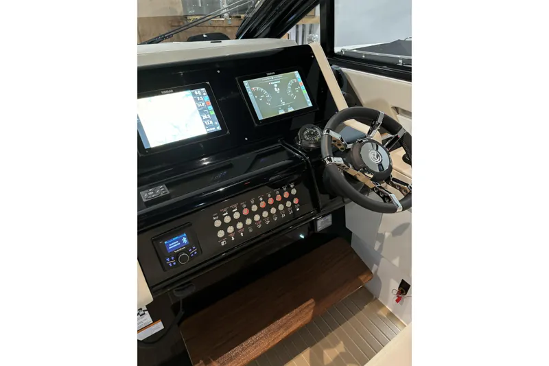 Slide: The Image of 2024 Cruisers Yachts 42 GLS OB helm with dual displays and modern controls. - 19