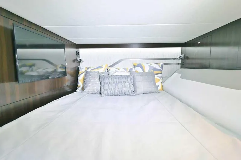 Slide: The Image of Luxurious cabin interior of 2024 Cruisers Yachts 42 GLS OB with modern bedding and TV. - 26