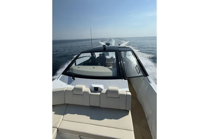 Slide: The Image of 2024 Cruisers Yachts 42 GLS OB cruising on open water under clear skies. - 5