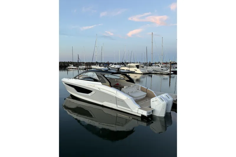 Slide: The Image of 2024 Cruisers Yachts 42 GLS OB docked in a serene marina setting. - 3