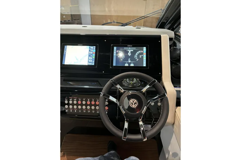 Slide: The Image of 2024 Cruisers Yachts 42 GLS OB helm with modern controls and dual displays. - 20