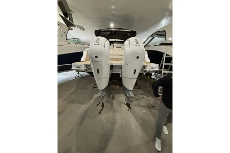 Slide: The Image of 2024 Cruisers Yachts 42 GLS OB with dual outboard engines in a showroom. - 12