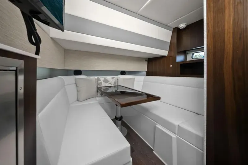 Slide: The Image of Luxurious interior of 2024 Cruisers Yachts 42 GLS OB with elegant seating and table. - 24