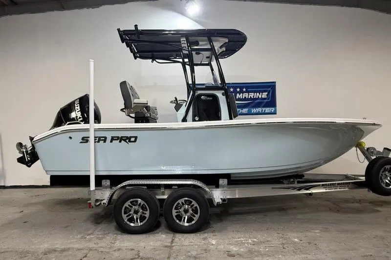 The Image of 2026 Sea Pro 202 Center Console boat on trailer in showroom. - 0